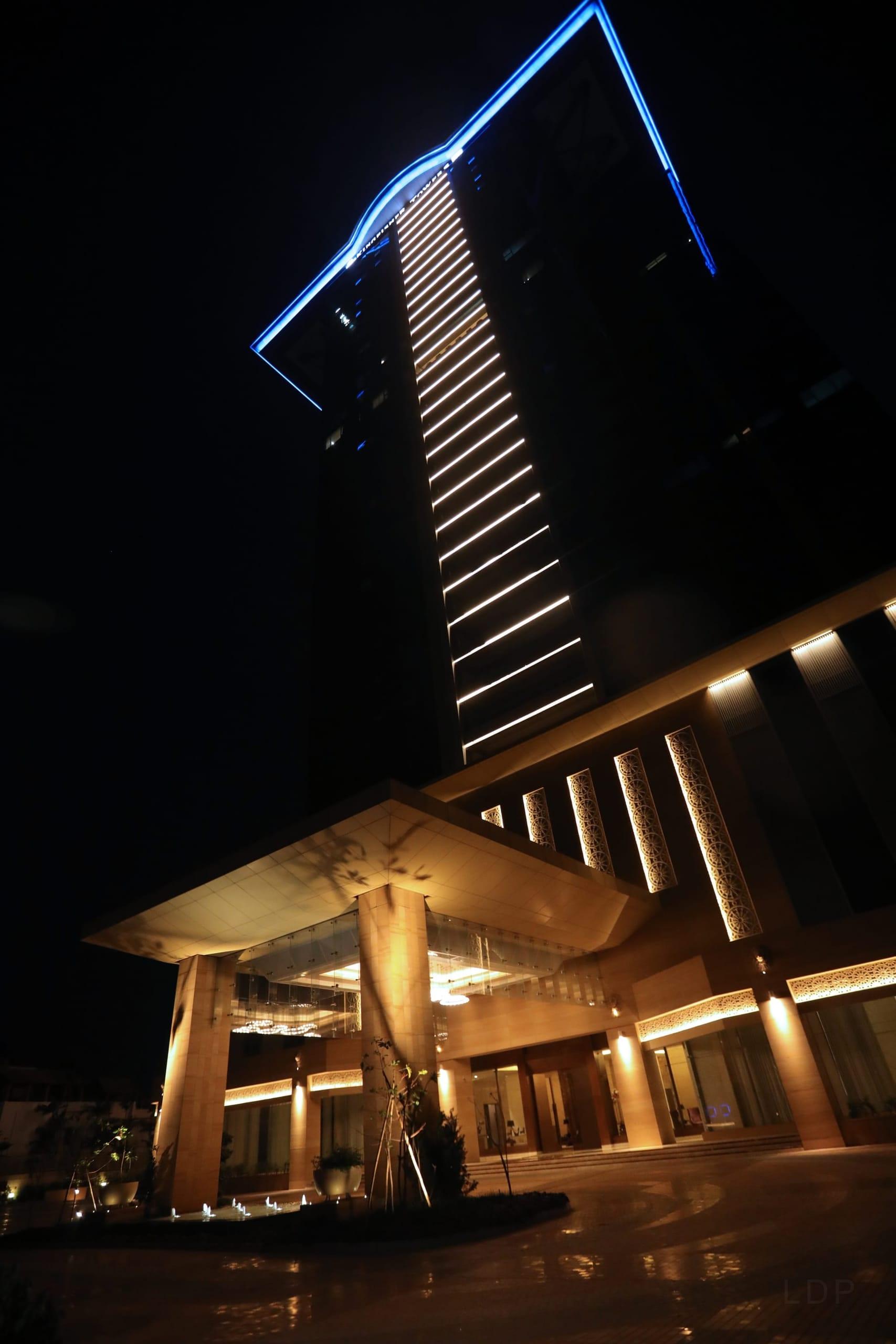 A contrarian palette for the tallest tower — cool, private, and layered.